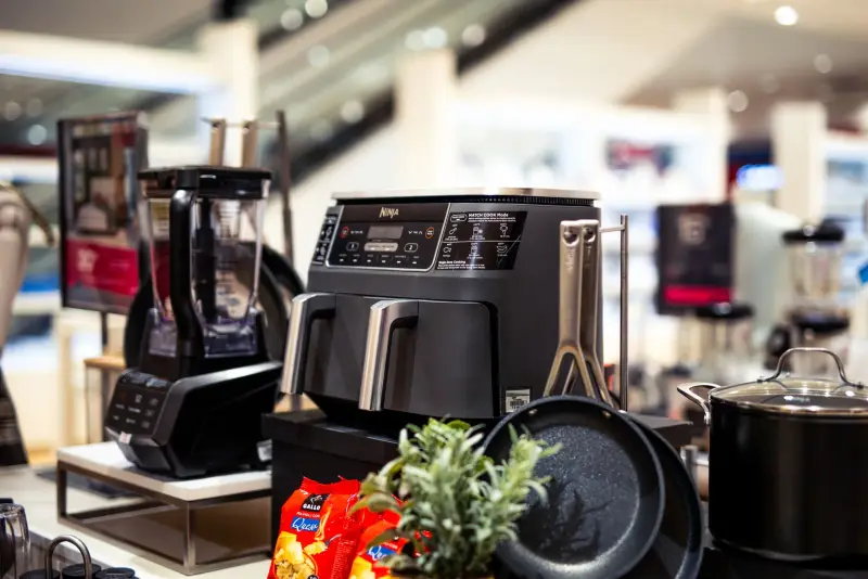 Kitchen appliances and cookware on display in a store