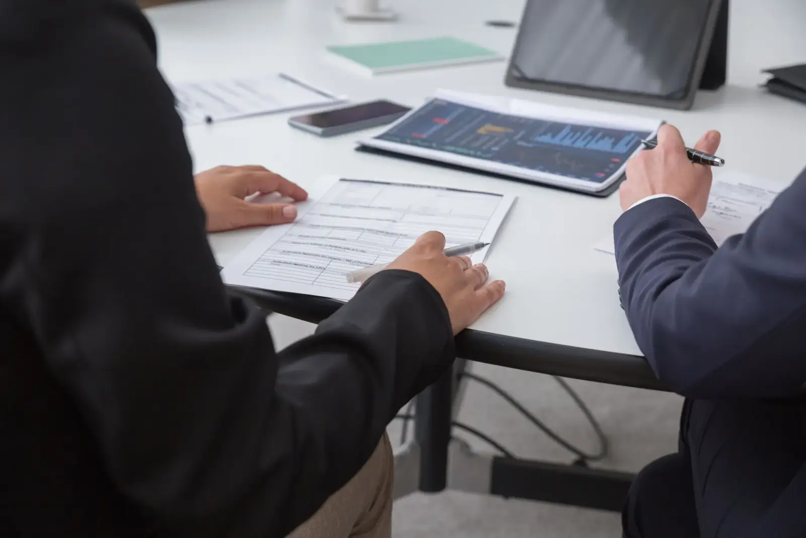 Two professionals reviewing a document together