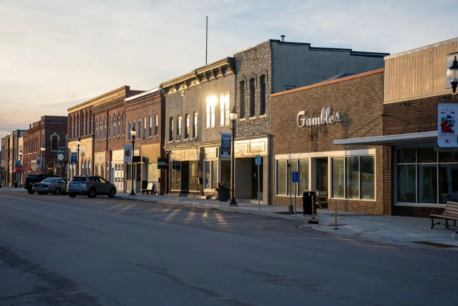 Historic main street with independent storefronts at sunset in a small American town